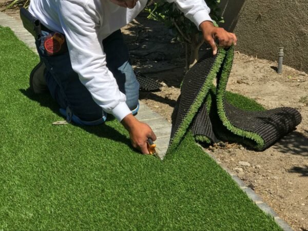 A Man Cutting Artificial Grass in Dubai Home